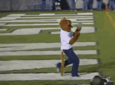 Mascot Running On Football Field In White Shirt And Blue Jeans GIF