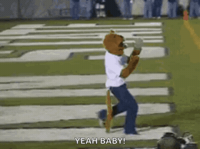 Mascot Running On Football Field In White Shirt And Blue Pants GIF