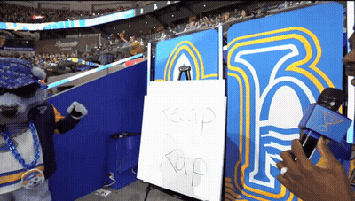 Mascot Standing In Front Of Keep Rap Sign GIF