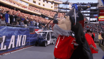 Mascot Standing In Front Of Land Banner GIF