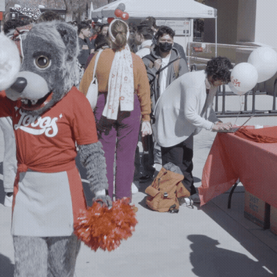 Mascot Wearing Loves Shirt In Crowd GIF