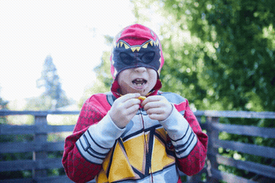 Masked Boy Eating Snack In Red Hoodie GIF
