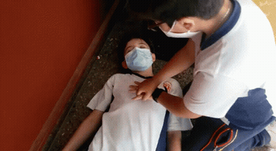 Masked Boy Lying On Floor, Man Holding Chest GIF