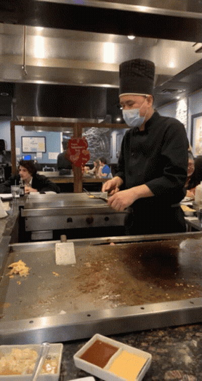 Masked Chef Preparing Food Near Valentine's Day Sign GIF