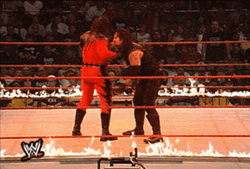 Masked Kane Chokeslam Opponent On Burning Ring GIF