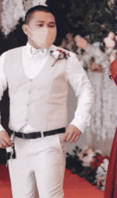 Masked Man In White Suit On Red Carpet GIF