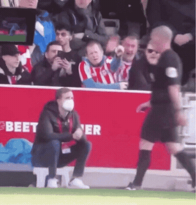 Masked Man Kneeling Before Referee On Soccer Field GIF