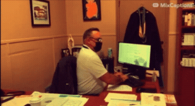 Masked Man Typing On Computer GIF