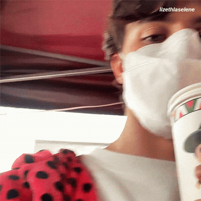 Masked Person Holding Coffee Cup With Name Lizethlaselene GIF