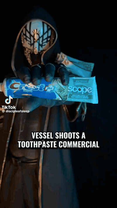 Masked Person Holding Crest Toothpaste GIF