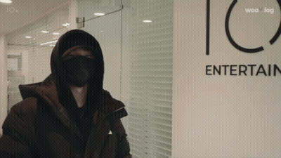 Masked Person in Front of Iox Entertainment Sign