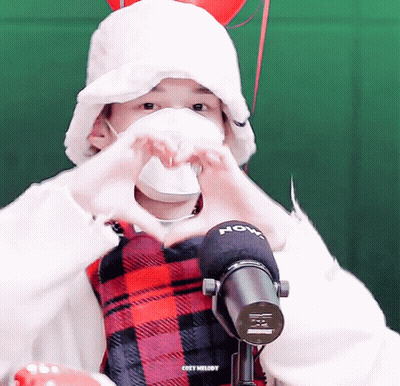 Masked Person Making Heart Beside Cozy Melody Microphone GIF