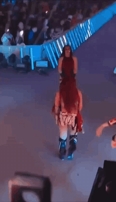 Masked Woman Dancing With Smackdown Sign GIF