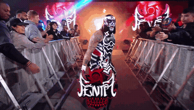 Masked Wrestler Carrying Jentel Sign In Crowd GIF
