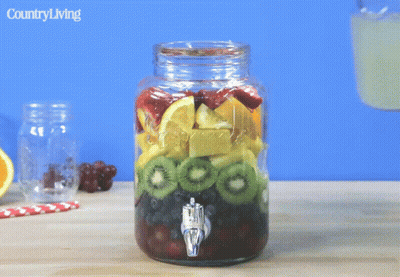 Mason Jar Fruit Pouring Into Glass Country Living GIF