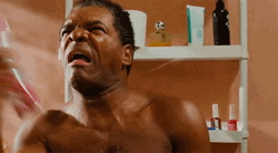 Matured Man Spraying Perfume In The Bathroom GIF