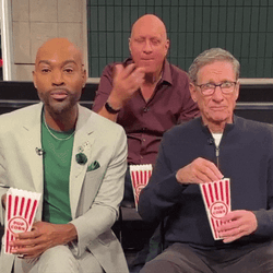 Maury Laughing And Eating Popcorn GIF