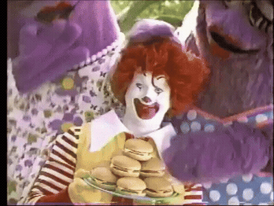 McDonald's Clown Holding Plate Of Hamburgers In Front Of Purple Monster GIF