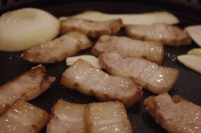 Meat Cooking In Pan With Onions And Garlic GIF