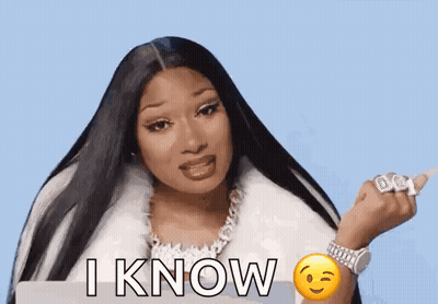 Megan Thee Stallion In White Fur Coat With Smiley Face Wrist GIF
