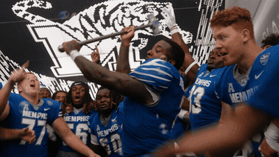 Memphis Football Players Holding Stick In Air GIF