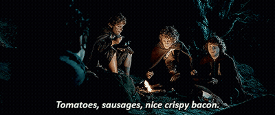 Men Around Campfire Eating Tomatoes Sausages Bacon GIF