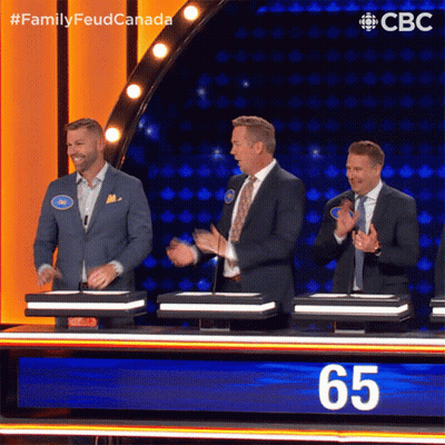 Men Around Table With Number 65 GIF