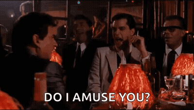 Men At Table With Red Lamps Asking Do I Amuse You GIF