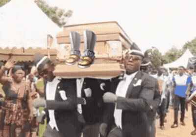 Men Carrying Coffin With Shoes GIF