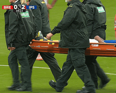 Men Carrying Stretcher On Soccer Field Scoreboard Says Bre 0 2 Ips GIF