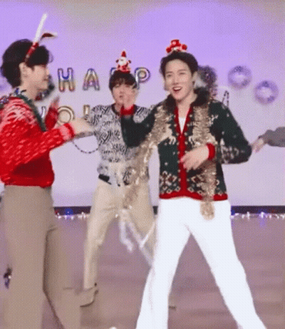 Men Dancing In Christmas Sweaters On Stage GIF