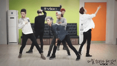 Men Dancing In Front Of VBX Sign GIF