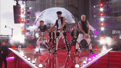 Men Dancing On Stage Under Devil Sign GIF