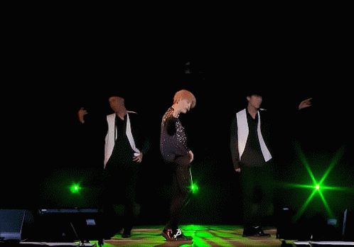 Men Dancing On Stage With Green Lights GIF