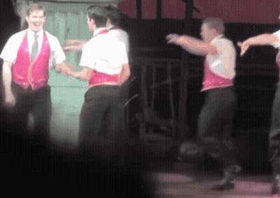 Men Dancing On Stage With Pink Vest GIF