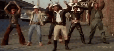 Men Dancing On Street In Front Of Building GIF