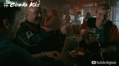 Men Drinking Beer At Table With YouTube Originals Ad GIF