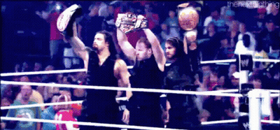 Men Holding Championship Belts In Wrestling Ring GIF