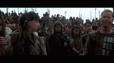 Men Holding Spears In Front Of Crowd GIF