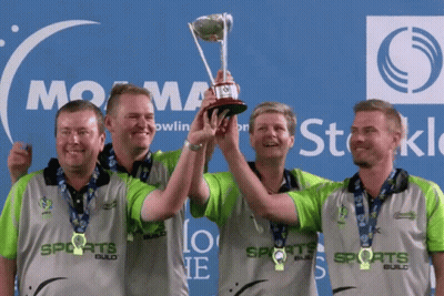 Men Holding Trophy In Front Of Sports Logo GIF