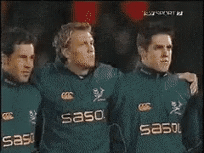 Men In Black Adidas Shirts Standing In Line GIF