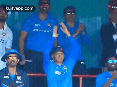 Men In Blue Shirts Applauding In Stadium GIF