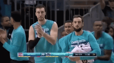 Men In Blue Shirts Applauding In Stadium GIF