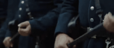 Men In Blue Uniforms Standing In Line GIF
