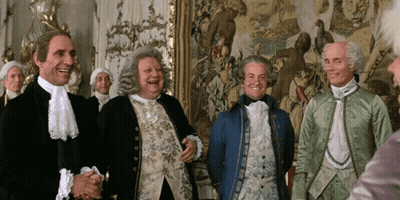Men In Costume Laughing In Front Of Tapestry GIF
