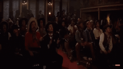 Men In Cowboy Hats Sitting In Dark Room GIF