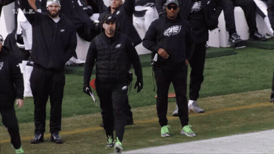 Men In Eagles Sweatshirts Walking On Football Field GIF
