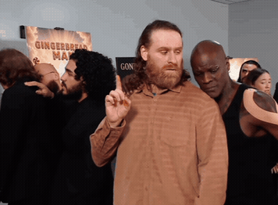 Men In Front Of Gingerbread Man Sign GIF