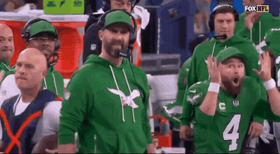 Men In Green Hoodies And Hats In Stadium GIF