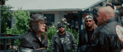 Men In Leather Jackets And Helmets In Front Of House GIF